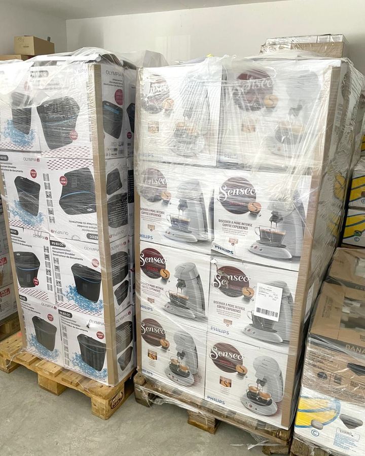 Two shrink-wrapped pallets of branded stock — Philips Senseo coffee machines and Olympia document shredders — in a warehouse