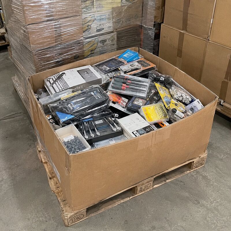 Boxed tools and hardware items in an open box on a pallet